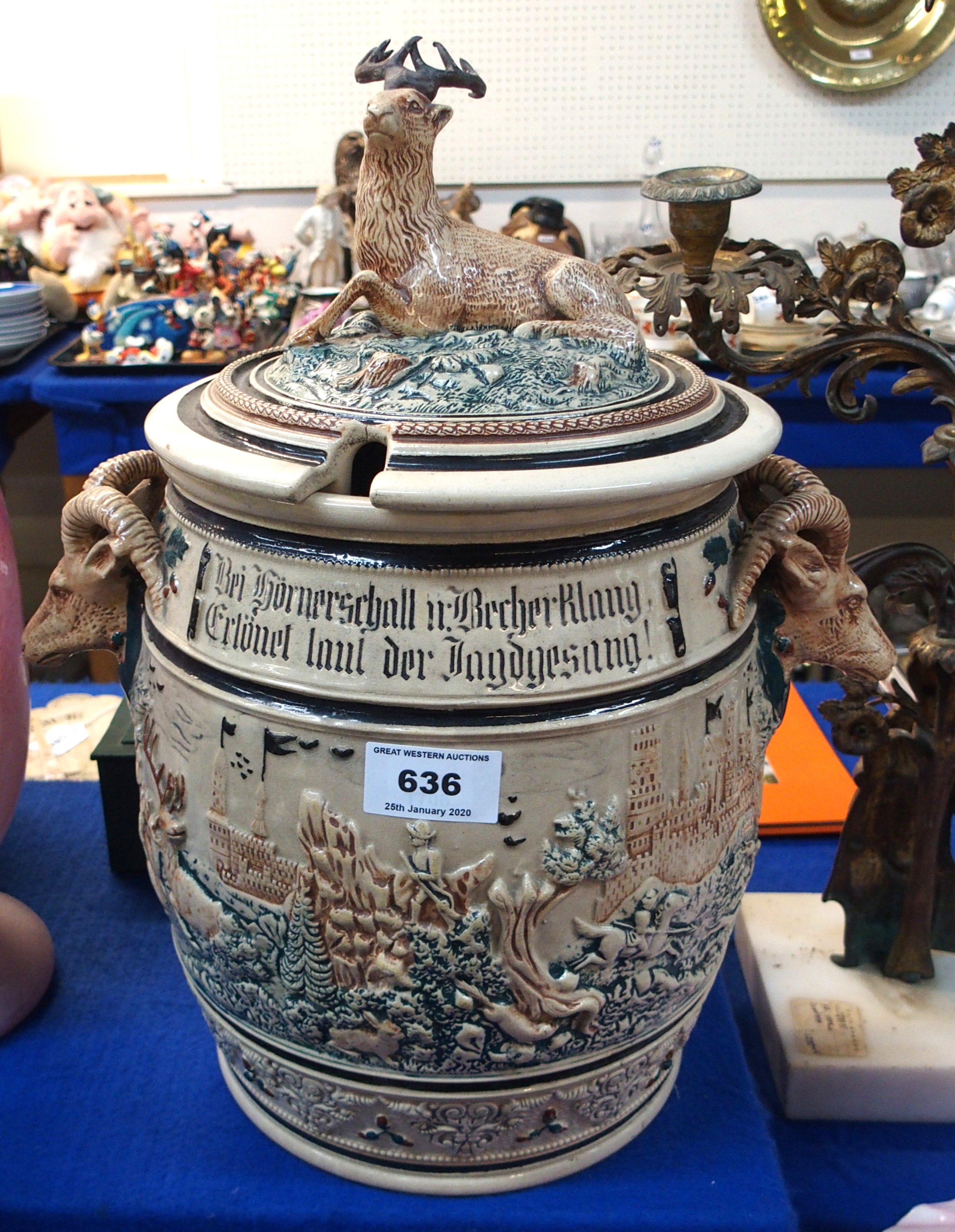 A large stoneware jar and cover, with goat head handles and stag mounted lid Condition Report: