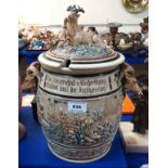 A large stoneware jar and cover, with goat head handles and stag mounted lid Condition Report: