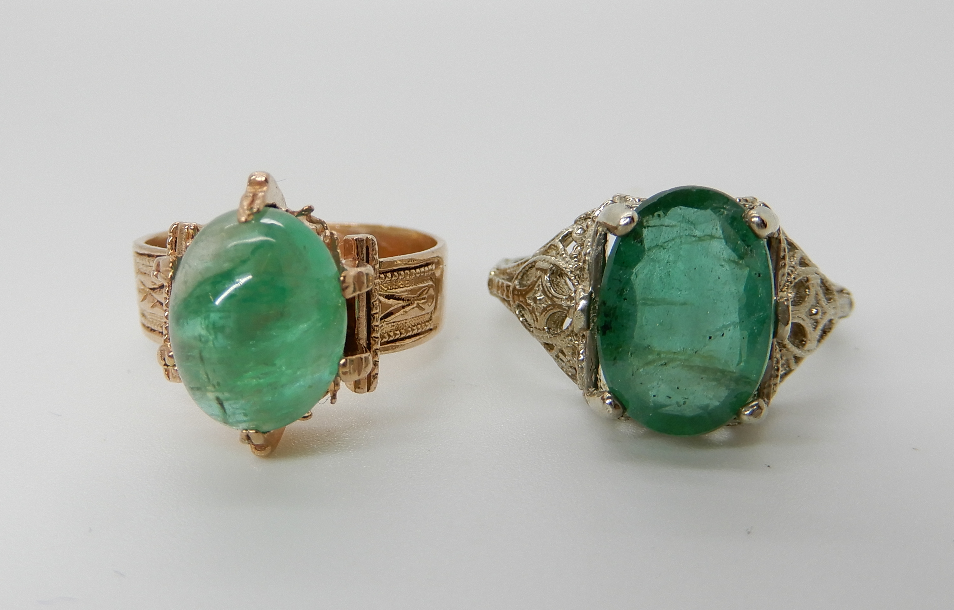 Two yellow metal rings set with green gemstones, pierced example N1/2, other size M, weight 6.4gms