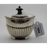 A silver tea caddy, London 1898, of oval form with hinged cover and half ribbed body, 9cm high,