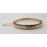 A 9ct gold bangle, inner dimensions 6cm x 5cm, weight 8.6gms Condition Report: Available upon