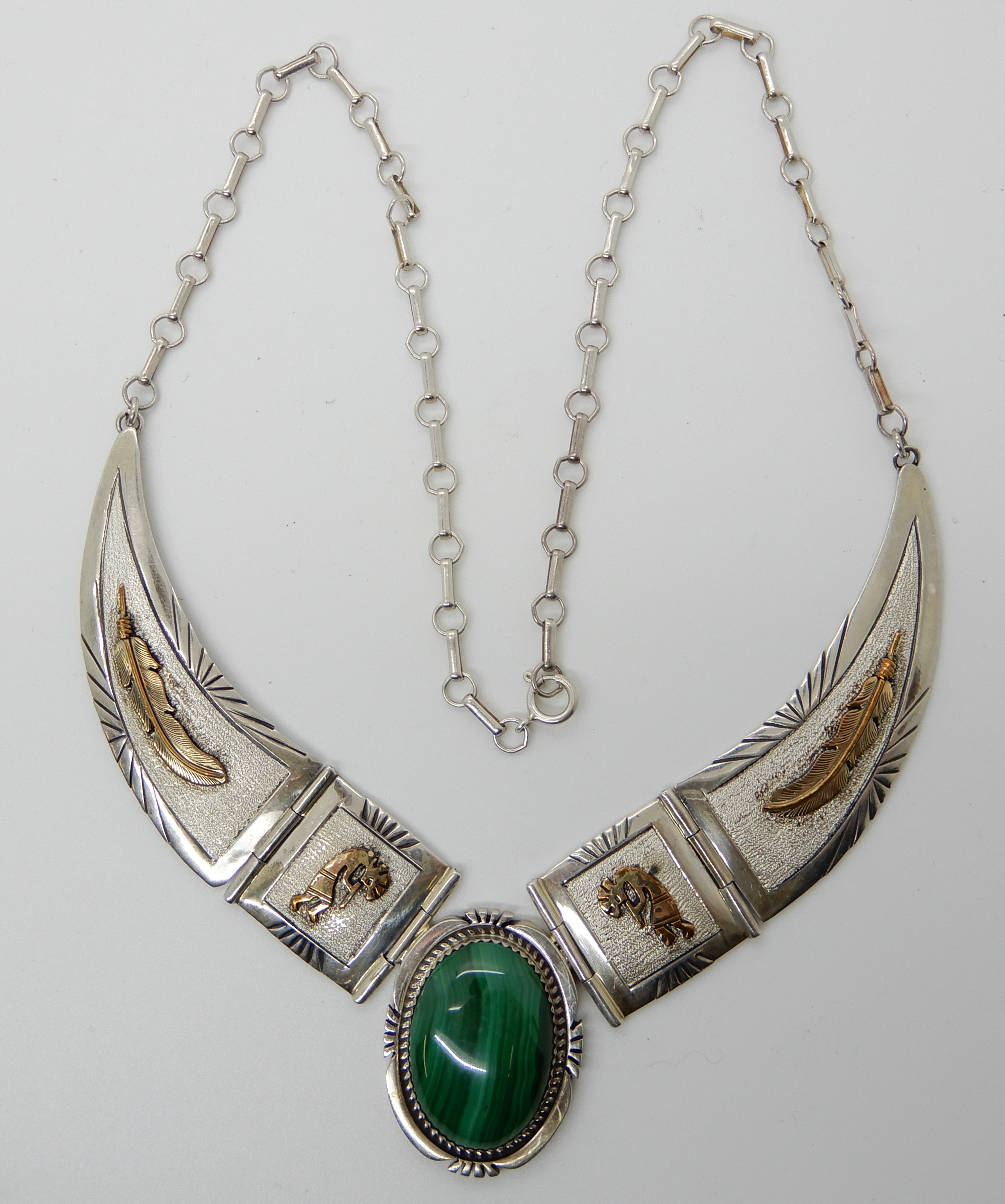 A silver Navaho design necklace with gold plated detail further set with malachite, by Mark Yazzie