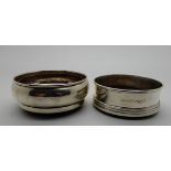 A lot comprising two silver wine coasters, Birmingham 1986 and 1987, 9cm and 9.5cm diameter