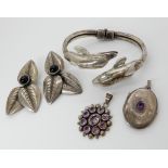 A silver dolphin bangle, two amethyst pendants and a pair of earrings Condition Report: Not