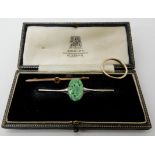 A 9ct white gold Chinese green hardstone set bar brooch, length 5.7cm, hardstone 17mm x 11mm, a