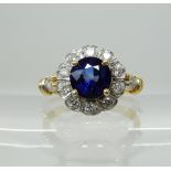 A blue gem and diamond cluster ring, size M1/2, weight 3.2gms Condition Report: Available upon
