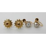 A pair of 18ct mounted pearl earrings with screw backs and a pair of 9ct gold star earrings weight