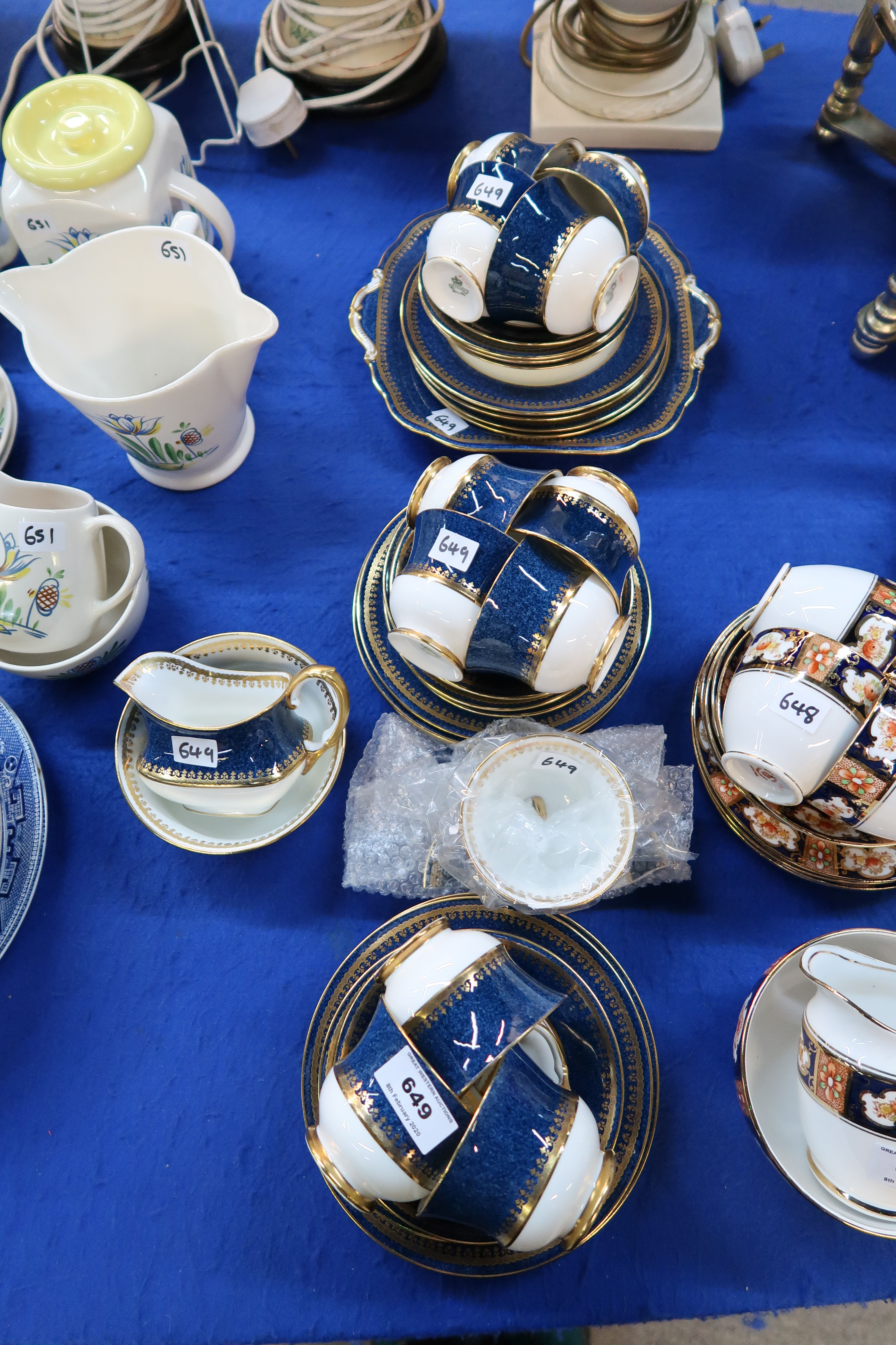 An Aynsley teaset with mottled blue band with gilt decoration comprising milk jug and sugar bowl,