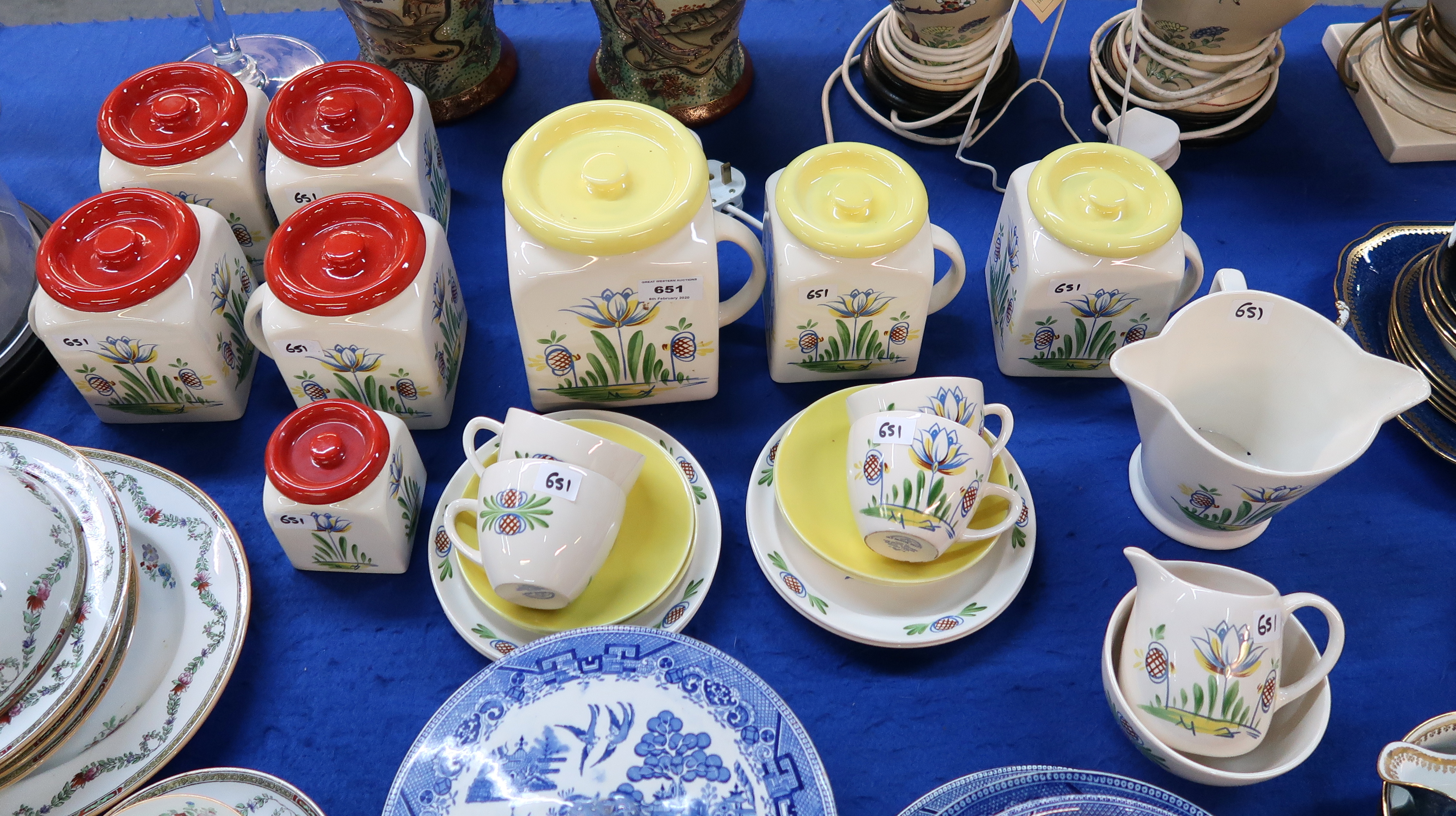 A collection of Old Bristol Delft pottery including three yellow topped storage jars, five red