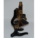 A black lacquer and brass microscope by E. Leitz in oak case with various slides Condition Report: