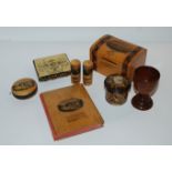 A small collection of Mauchline ware including money box, two needle cases, pin cushion etc