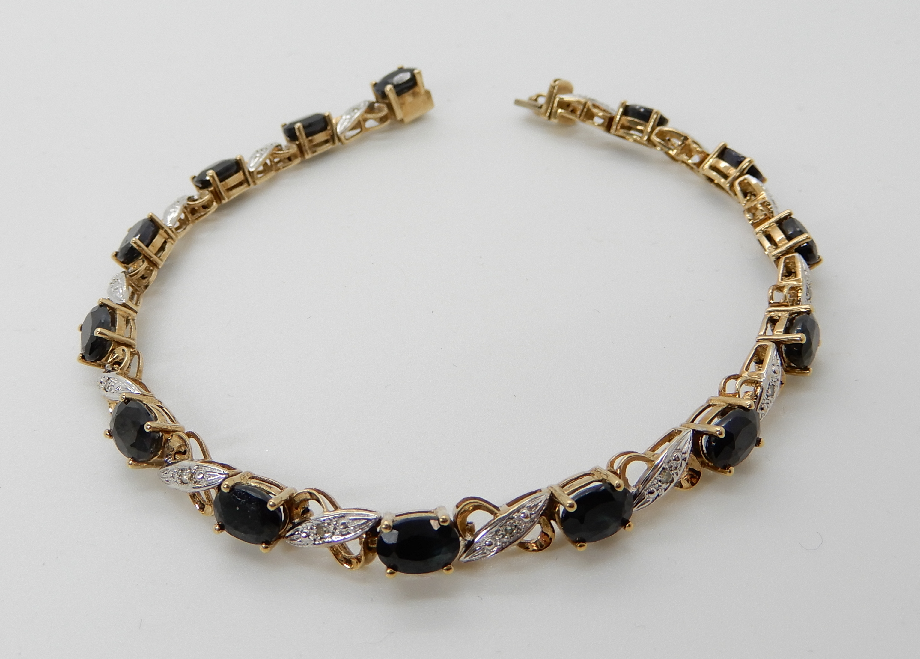 A 9ct gold sapphire and diamond accent bracelet, length 18cm, weight 9.6gms Condition Report: