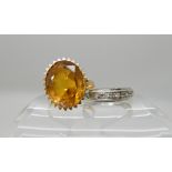 A yellow metal ring set with a yellow gem size N, weight 7.2gms, together with an 18ct white gold