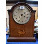 An Edwardian mantle clock inlaid with a butterfly, the Peerless movement numbered 103782 Condition