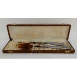 A cased pair of silver plate handled salad servers Condition Report: Available upon request