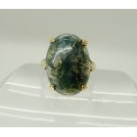 A 9ct gold ring set with a moss agate, size P, weight 5.6gms Condition Report: Available upon