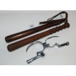 Two hardwood truncheons and pair of handcuffs Condition Report: Available upon request
