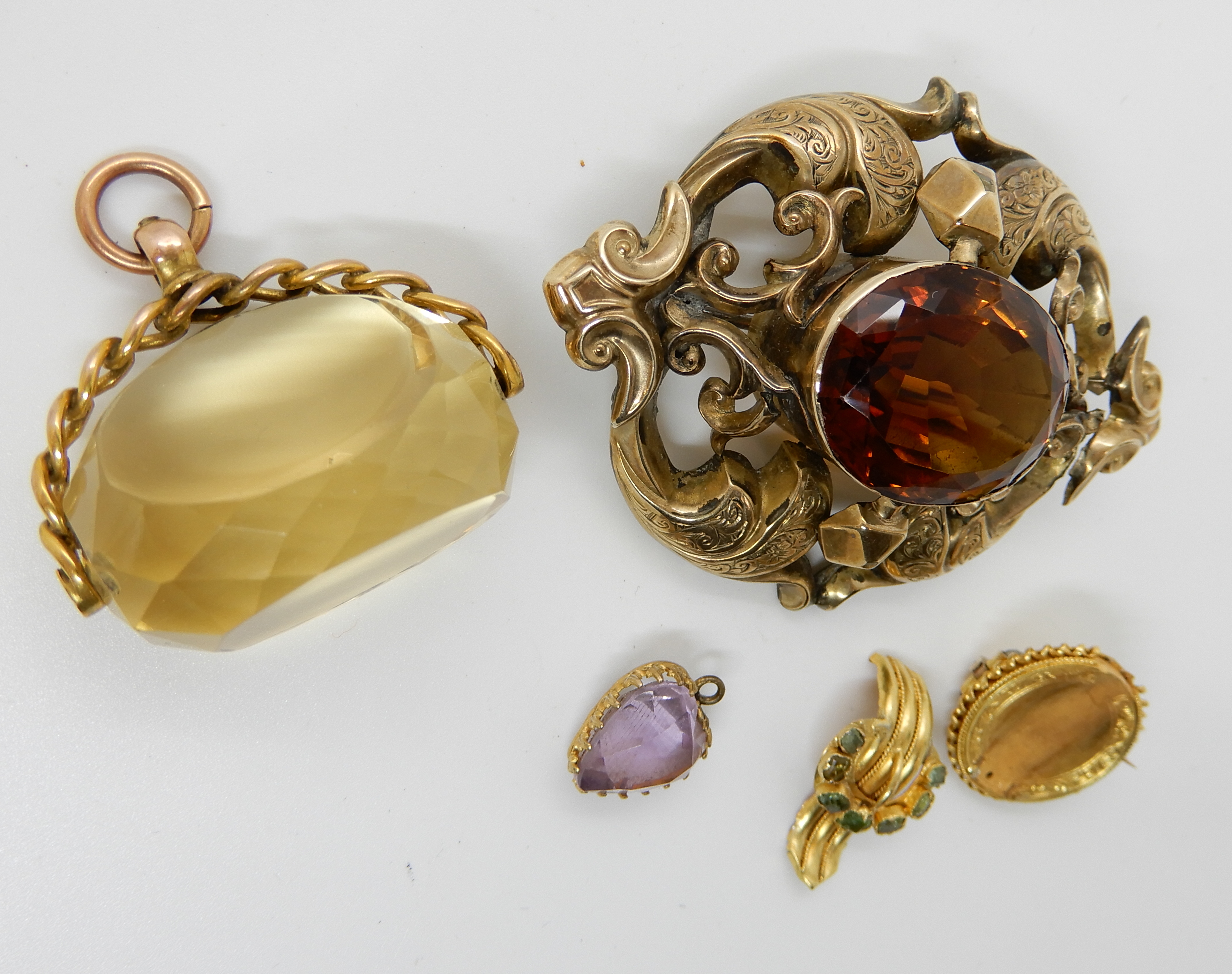 A 9ct gold citrine fob seal, a yellow metal brooch set with green gems, a yellow metal amethyst - Image 2 of 2