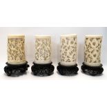 Four carved ivory tusks on stands Condition Report: Available upon request