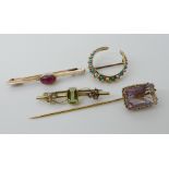 A continental gold ruby set brooch, a 15ct peridot and pearl brooch, a yellow metal turquoise and