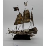 A white metal model of an armed junk, 15cm long Condition Report: Available upon request