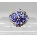 A 9ct gold tanzanite and diamond flower ring head size approx 17mm, finger size N, weight 2.8gms