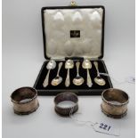 A lot comprising a cased set of six silver teaspoons, Birmingham 1948 and three silver napkin