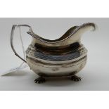 A silver cream jug, London 1811, on four shell pad feet, 154gms Condition Report: Available upon