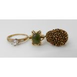 A 9ct gold garnet dome ring, size O, a 10k New Zealand jade set retro ring size L and a 9ct gold