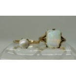 A yellow metal ring set with an opal (af) size K and a yellow metal pearl set ring size L1/2,