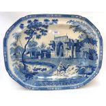 A large blue and white meat platter depicting a palace with a river in front and a man on a camel