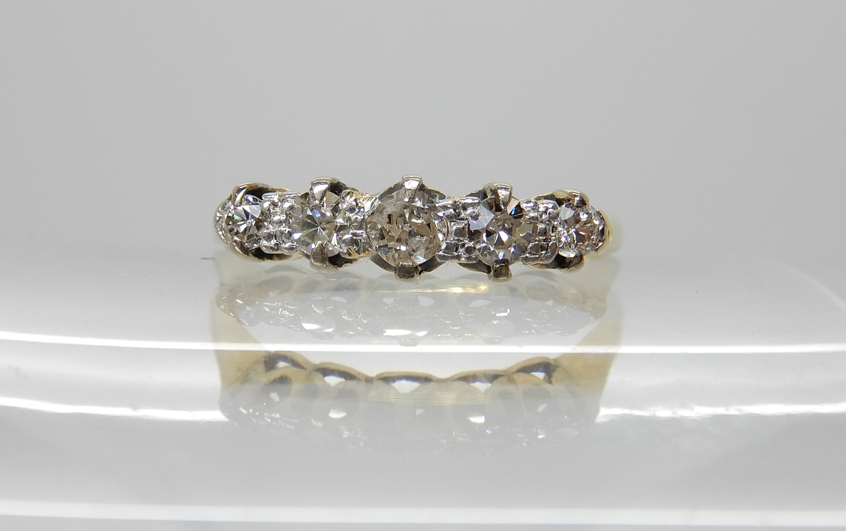 An 18ct gold five stone diamond ring, size P, weight 2.4gms Condition Report: middle diamond has a