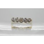An 18ct gold five stone diamond ring, size P, weight 2.4gms Condition Report: middle diamond has a
