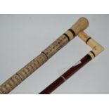 A bone handle walking cane and another walking cane (2) Condition Report: Available upon request