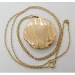 A 9ct gold back and front locket with a yellow metal chain, weight 8.5gms Condition Report: