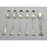 A lot comprising five silver teaspoons, Edinburgh 1926 and a sugar spoon with Celtic decoration,