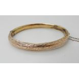 A 9ct gold engraved bangle, weight 8.4gms Condition Report: Available upon request