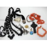 A collection to include jet beads, coral beads, bog oak cross, silver butterfly wing brooch for