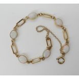 A 9ct gold bracelet set with white opals, length 16.5cm, weight 6gms Condition Report: Available