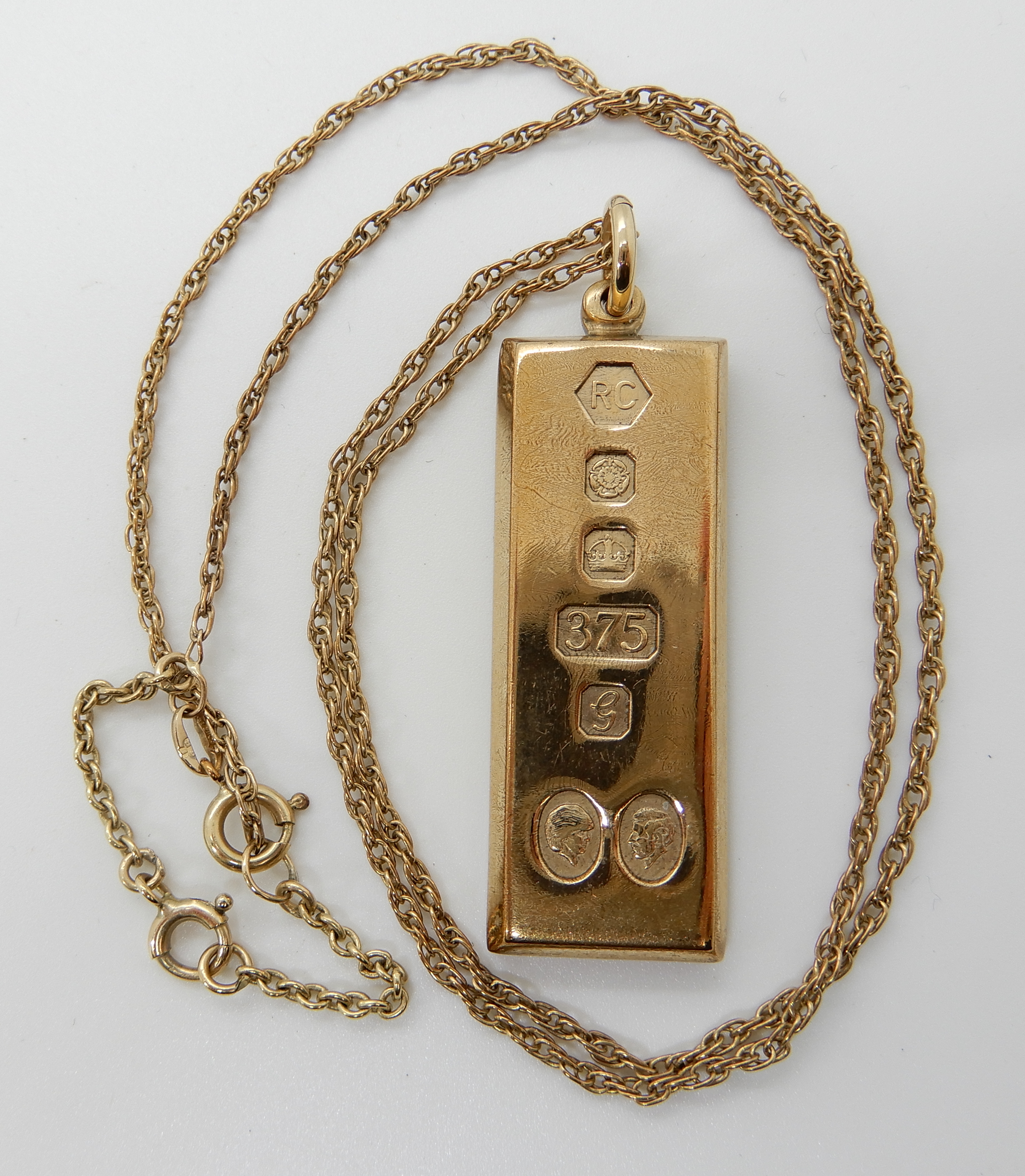 A 9ct gold Charles and Diana ingot pendant and rope chain, (length 46cm) combined weight 33.8gms