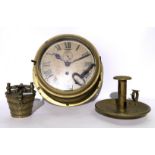 A brass circular bulkhead clock, graduated weights and candlestick Condition Report: Available