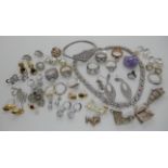 A collection of silver and costume jewellery to include gem set rings, a bangle earrings etc