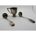 A lot comprising a silver christening mug, London 1934 and a pair of silver sauce ladles, Glasgow