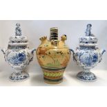 A pair of Delft style drug urns and covers and a pottery vessel Condition Report: Available upon