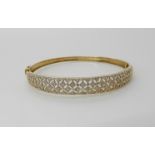 A 9ct gold diamond set pierced bangle, weight 8.8gms Condition Report: Available upon request