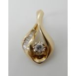 A 14k gold diamond pendant set with estimated approx 0.25cts of brilliant and baguette cut