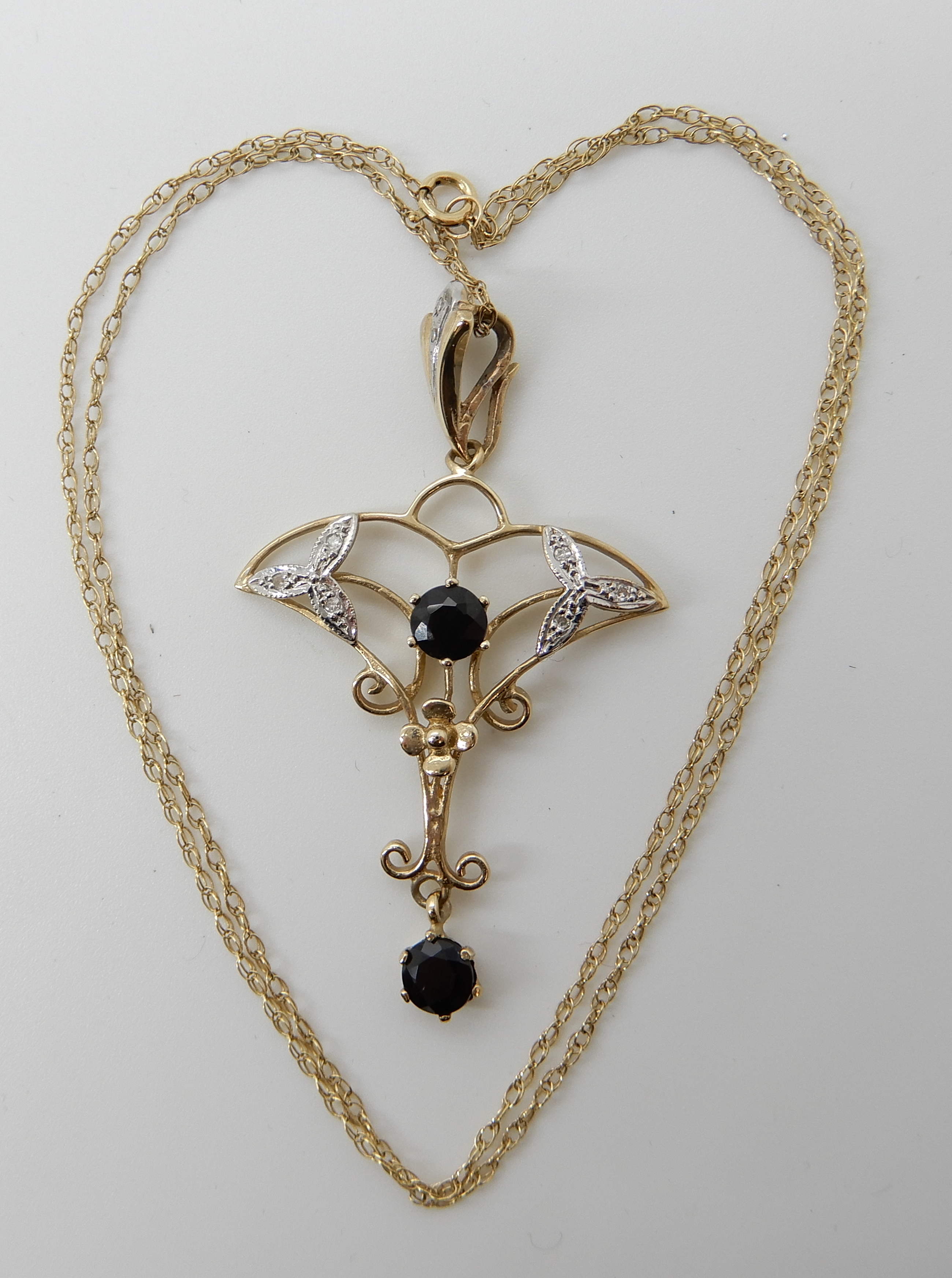 A 9ct gold sapphire and diamond Edwardian style pendant, length 4.6cm, length of chain 40cm,