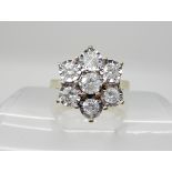 A 9ct gold diamond flower ring, set with estimated approx 0.80cts of brilliant cut diamonds,