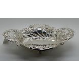 A silver fruit dish, Chester 1905, of oval shape with embossed and pierced decoration on four
