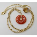 A 14k mounted Chinese rondel pendant, with a 9ct chain and a 9ct gold mother of pearl and diamond